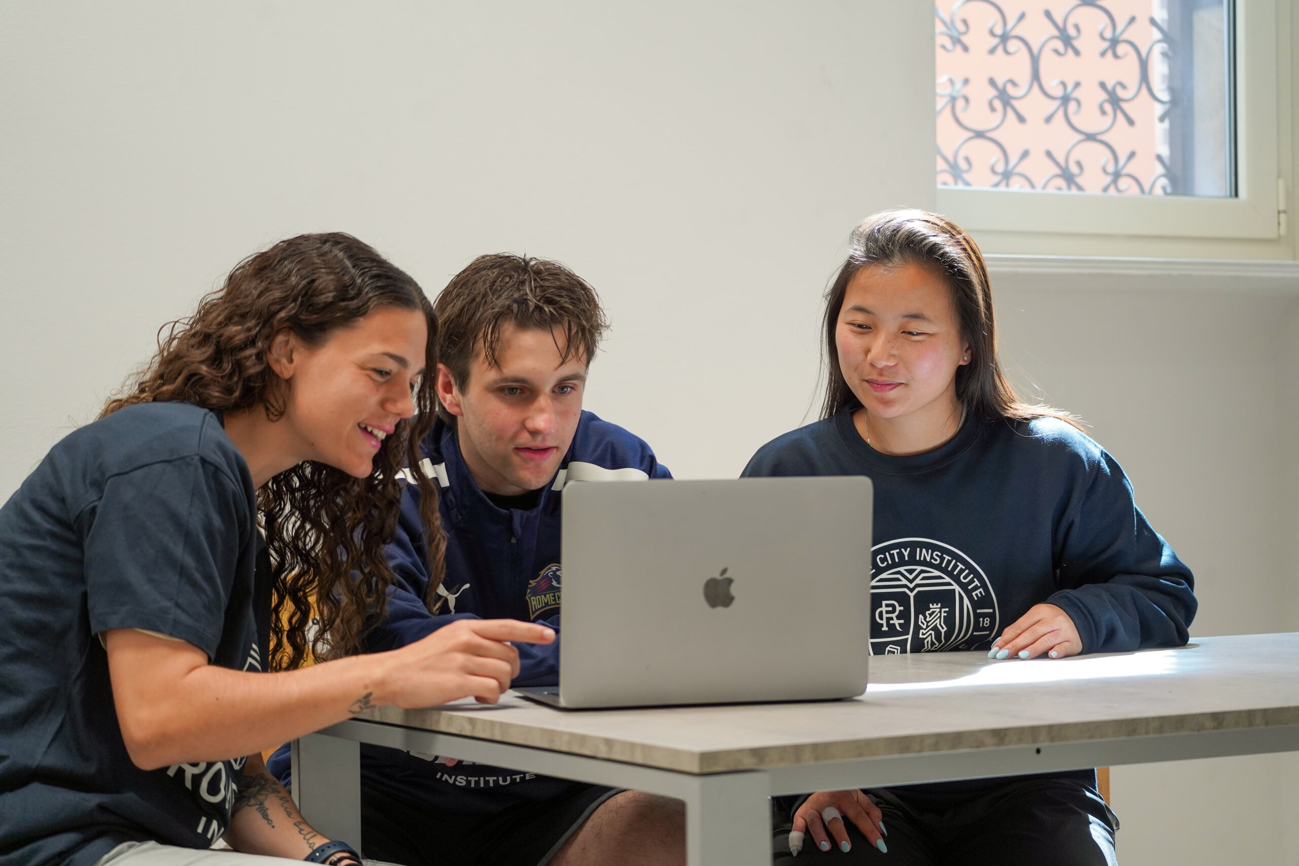 Rome City Institute students reviewing coursework together on a laptop