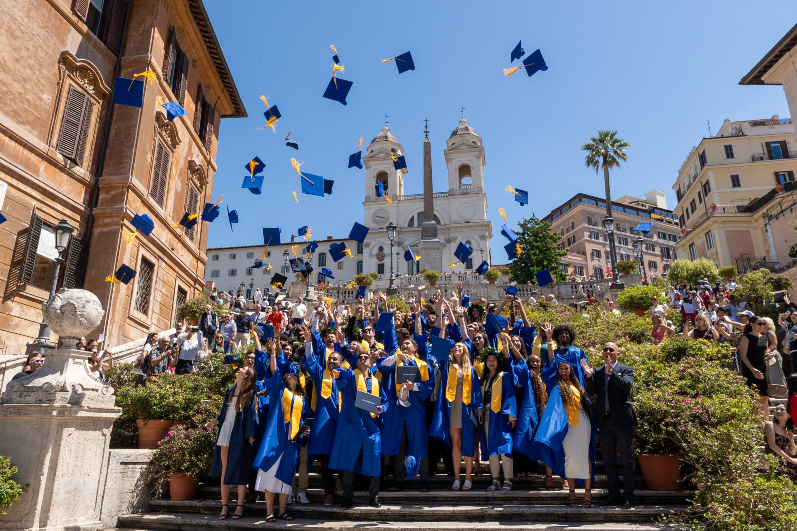 Rome City Institute graduates tossing caps at the Spanish Steps