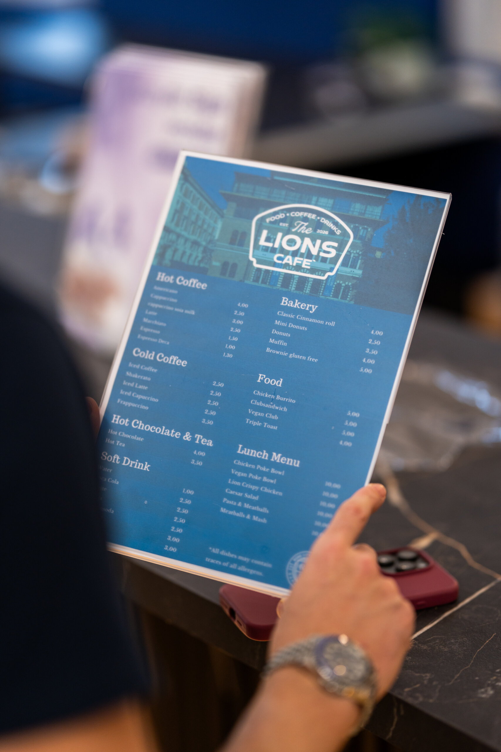 Student checking the Lions Cafe menu board