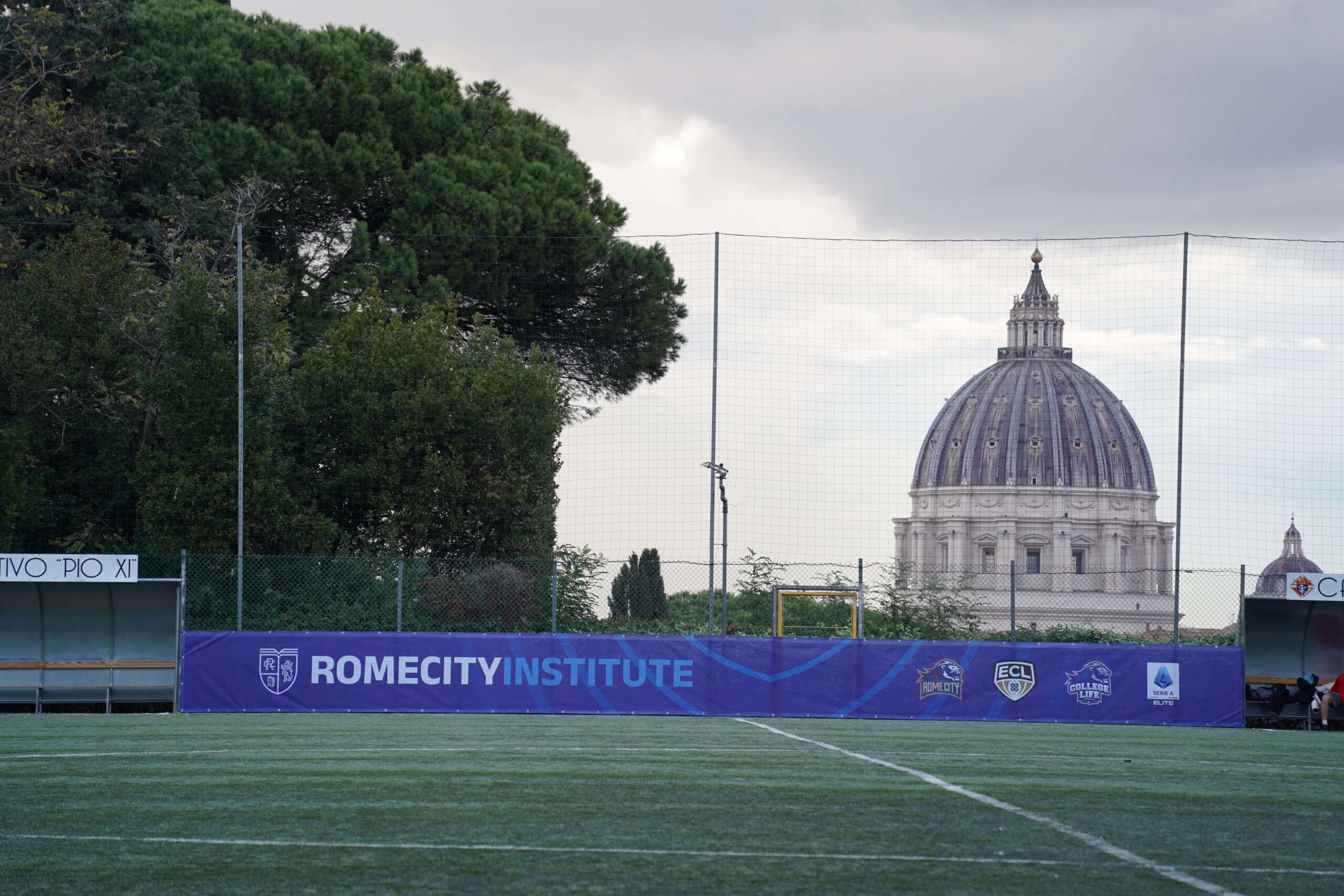 View of St. Peter's Basilica dome from the Rome City Training Center pitch, with Rome City Institute perimeter banners