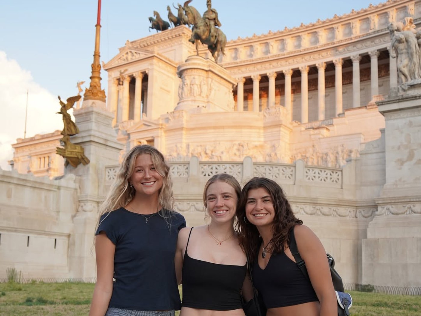 Three students in front of the Altare della Patria at Piazza Venezia, Rome